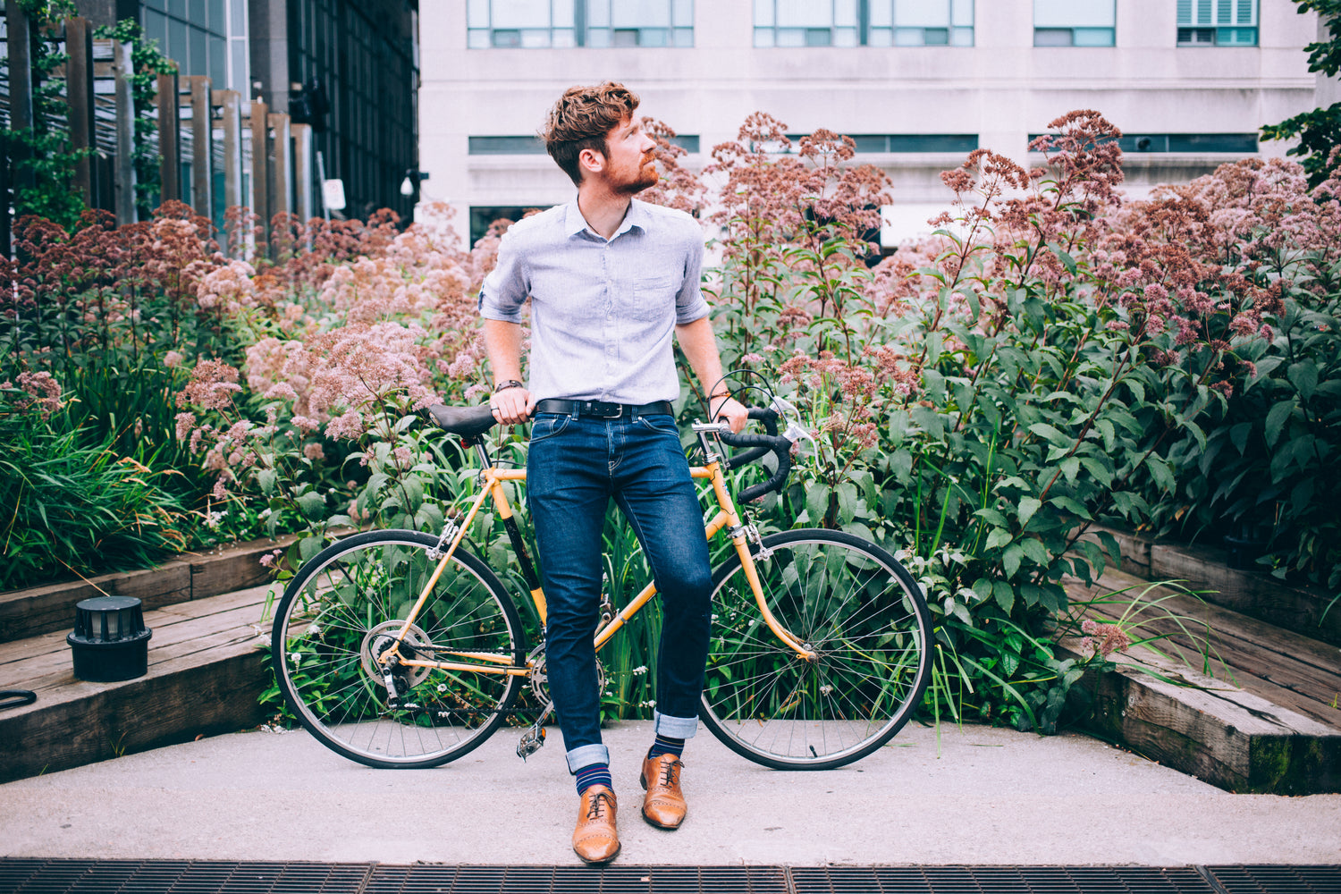 WithVesta - Mens Fashion Man In Shirt And Jeans Leaning On Bicycle